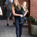 Hilary Duff is all smiles as she carries baby Luca into a Mommy & Me class in Los Angeles